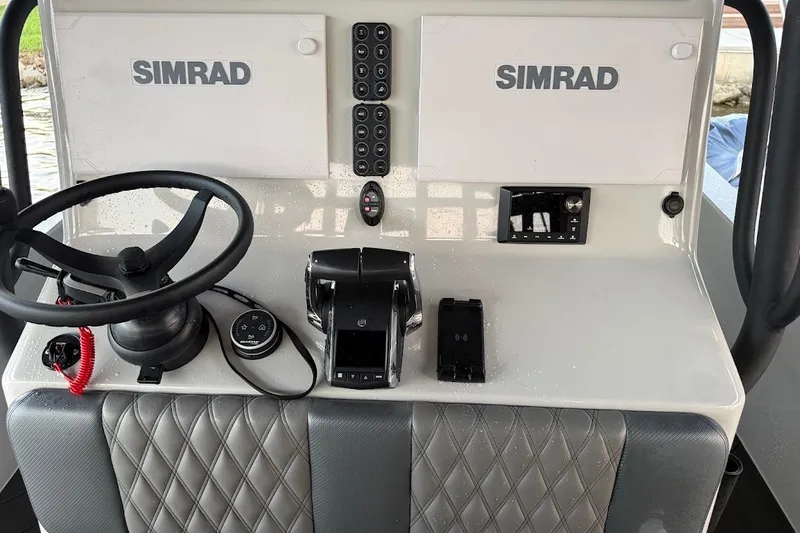 Slide: The Image of Helm of 2025 Shallow Sport 32 X3 boat with Simrad electronics and steering wheel. - 21