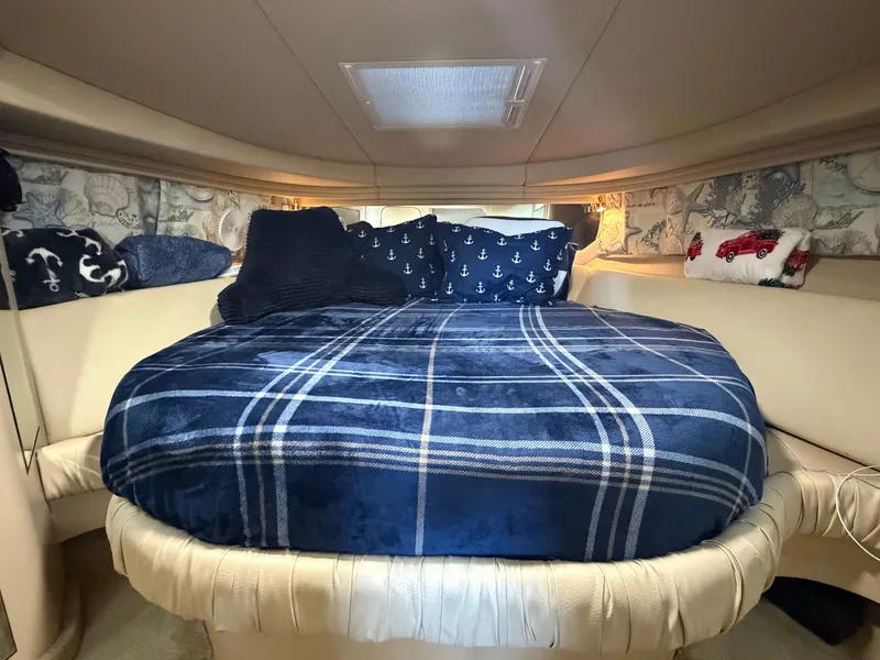 Slide: The Image of The image shows a cozy cabin with a large bed, decorated with blue and white pillows. - 17