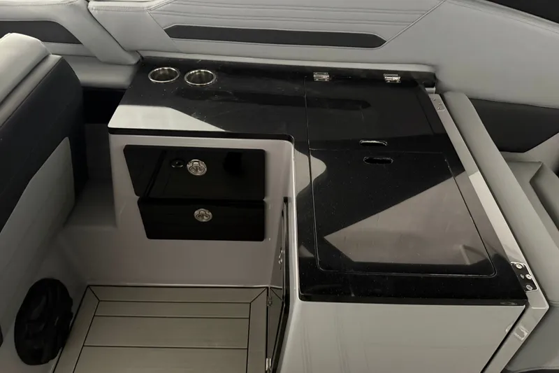 Slide: The Image of Interior of 2026 Yamaha Boats 295XD featuring sleek storage and cup holders. - 17