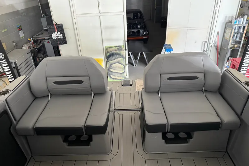 Slide: The Image of 2026 Yamaha Boats 295XD interior with gray seating in a workshop setting. - 5