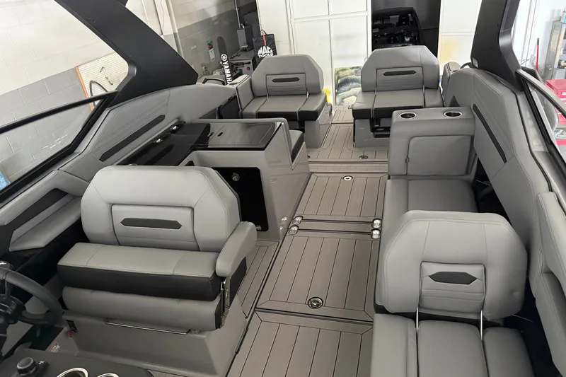 Slide: The Image of 2026 Yamaha Boats 295XD interior with sleek gray seating and modern design. - 16