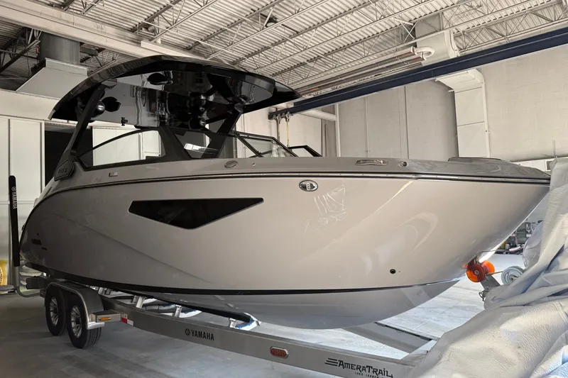 Slide: The Image of 2026 Yamaha Boats 295XD on trailer in indoor storage facility. - 19