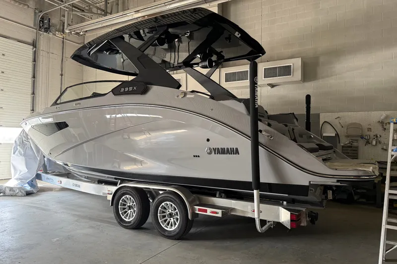 Slide: The Image of 2026 Yamaha Boats 295XD on trailer in a garage setting. - 1