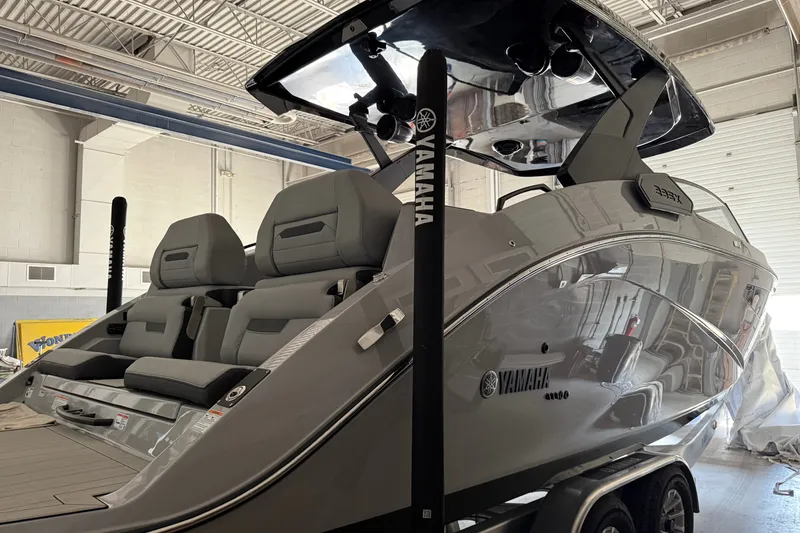 Slide: The Image of 2026 Yamaha Boats 295XD in showroom, featuring sleek design and modern seating. - 18