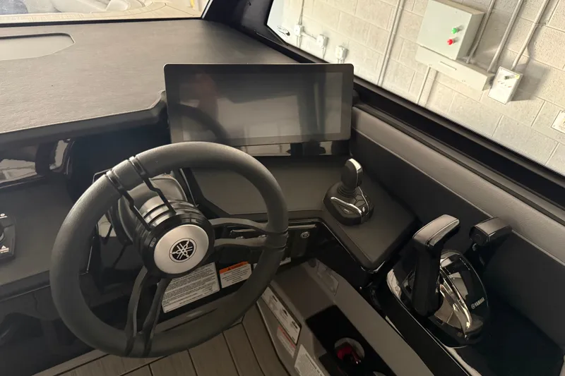 Slide: The Image of Steering console of 2026 Yamaha Boats 295XD with touchscreen and controls. - 12