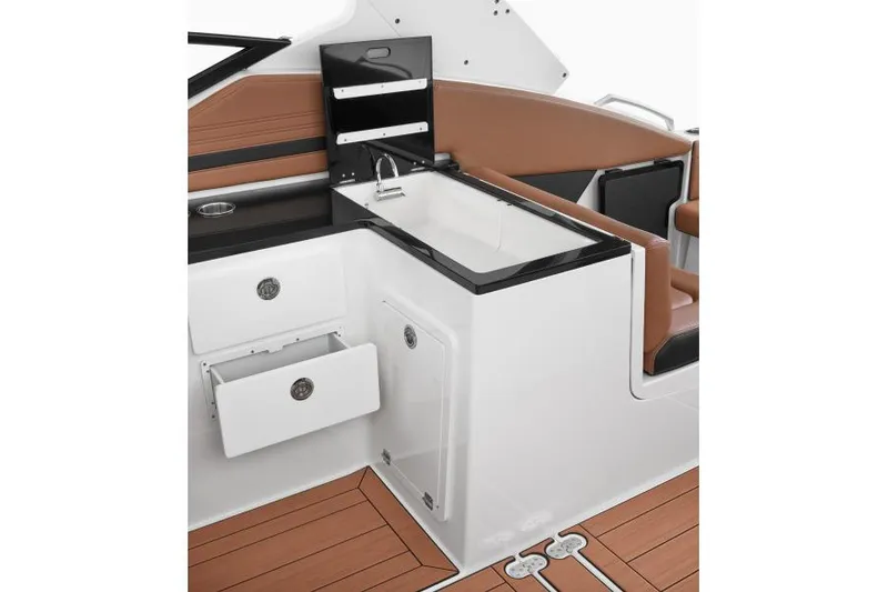 Slide: The Image of Manufacturer Provided Image: 2026 Yamaha Boats 295XD interior with sleek sink, storage, and brown seating. - 23