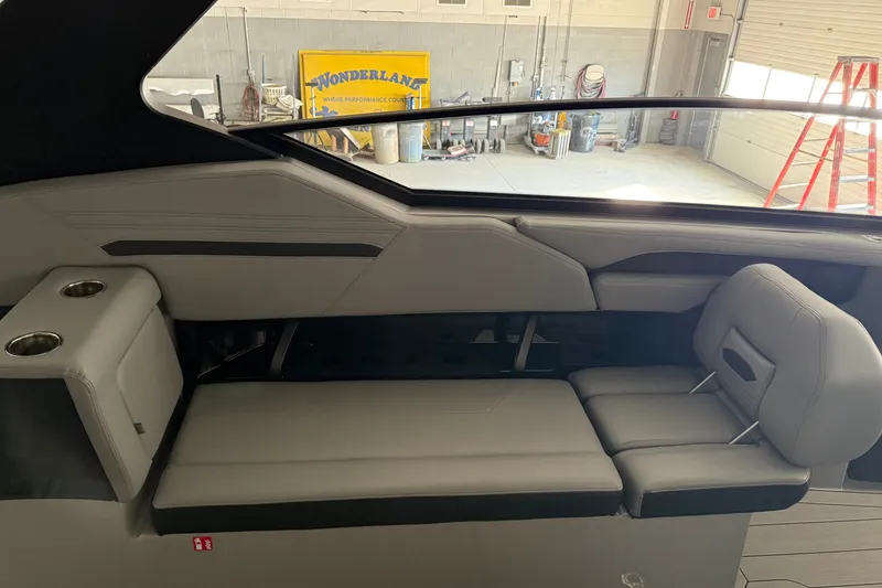 Slide: The Image of Interior seating of 2026 Yamaha Boats 295XD, featuring sleek gray upholstery and cup holders. - 9