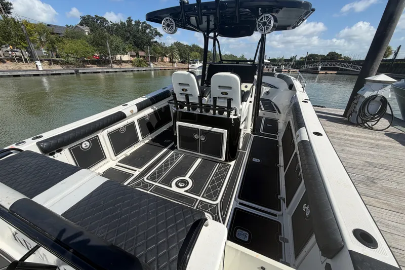 Slide: The Image of 2009 Century 3200 Center Console boat docked, featuring spacious seating and modern design. - 9