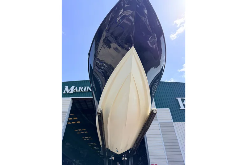 Slide: The Image of 2009 Century 3200 Center Console boat in marina, viewed from below against blue sky. - 41