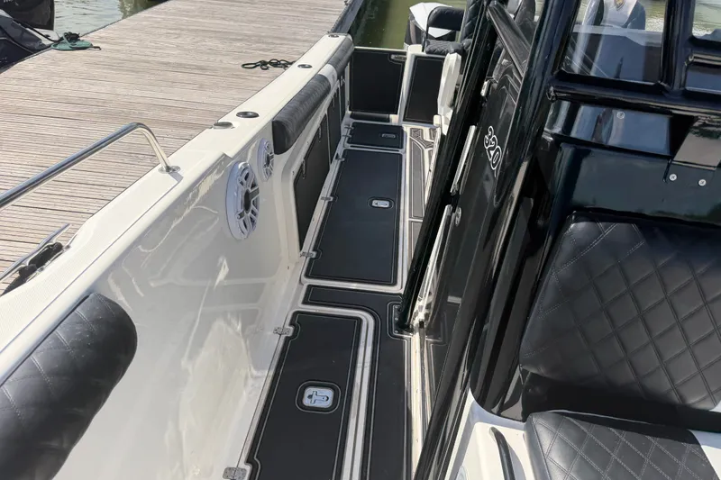 Slide: The Image of 2009 Century 3200 Center Console boat interior with black seating and deck details. - 23