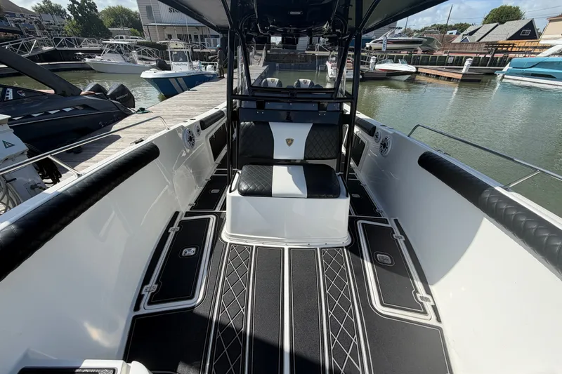 Slide: The Image of 2009 Century 3200 Center Console boat interior at marina, featuring sleek seating and modern design. - 19