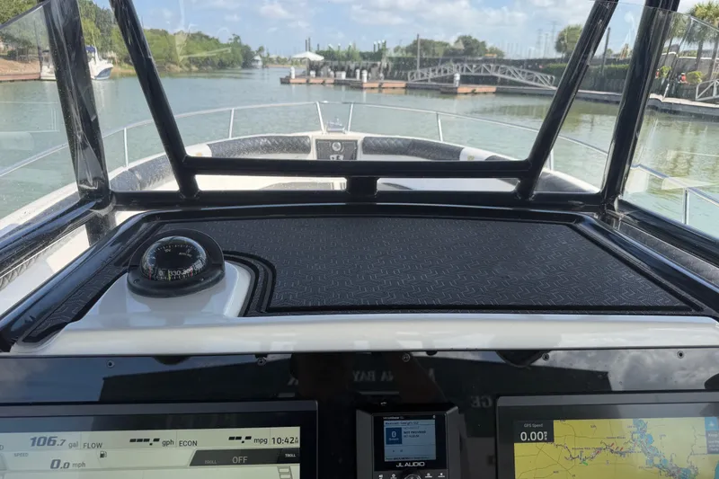 Slide: The Image of 2009 Century 3200 Center Console boat dashboard with navigation instruments and scenic waterway view. - 33