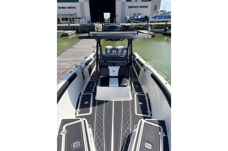 Slide: The Image of 2009 Century 3200 Center Console boat docked at marina, featuring sleek design and modern equipment. - 51