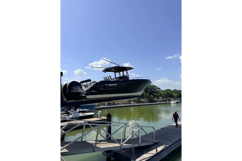Slide: The Image of 2009 Century 3200 Center Console boat docked on a sunny day by the water. - 42