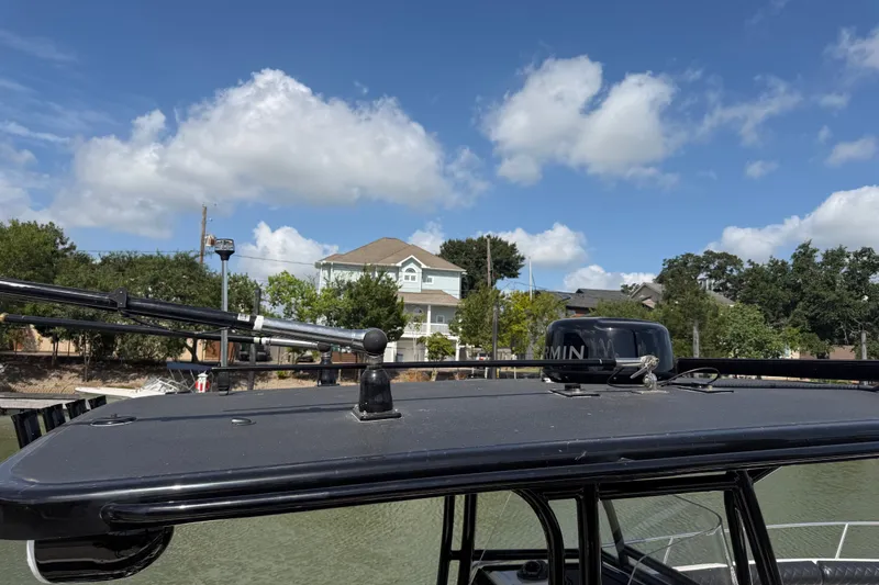 Slide: The Image of 2009 Century 3200 Center Console boat with Garmin equipment, docked under a clear blue sky. - 40