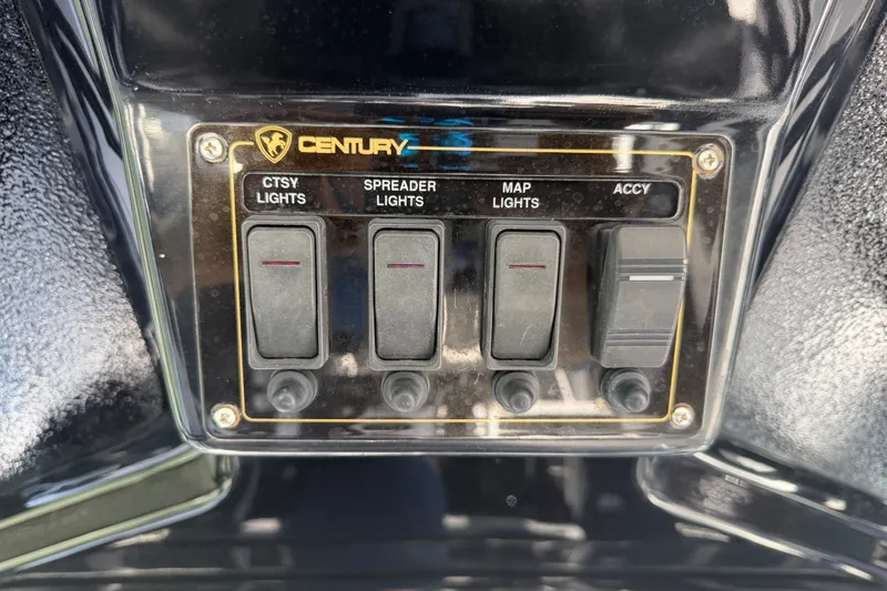 Slide: The Image of Control panel of a 2009 Century 3200 Center Console boat with labeled switches. - 27