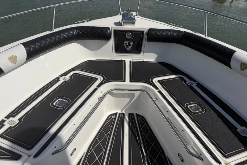 Slide: The Image of 2009 Century 3200 Center Console boat interior with cushioned seating and storage compartments. - 16