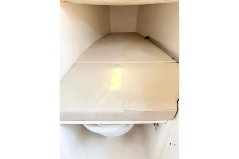 Slide: The Image of Interior cabin of a 2009 Century 3200 Center Console boat with beige cushions. - 43