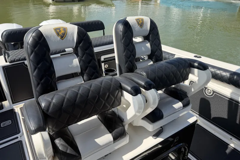 Slide: The Image of Luxurious seating on a 2009 Century 3200 Center Console boat, featuring quilted leather upholstery. - 25