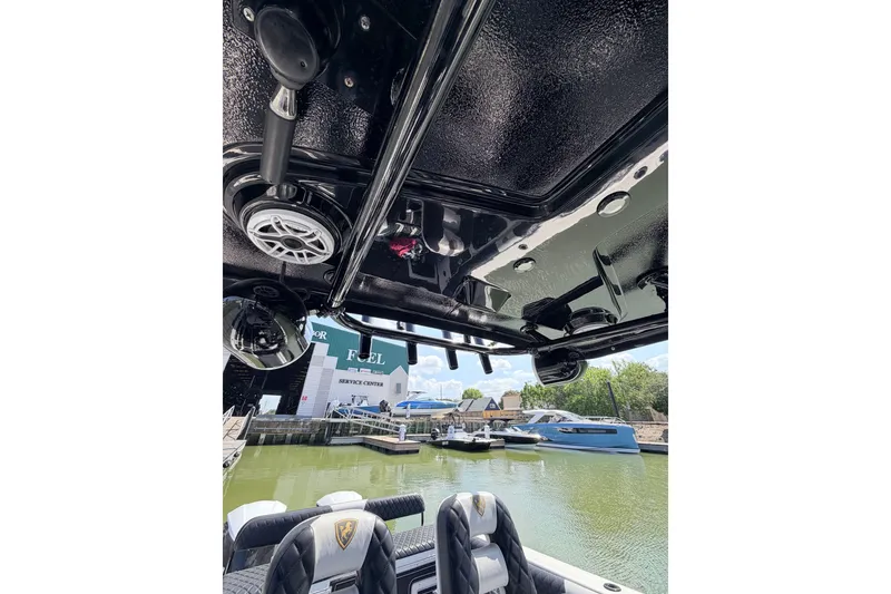 Slide: The Image of 2009 Century 3200 Center Console boat interior with speakers, docked near service center. - 53