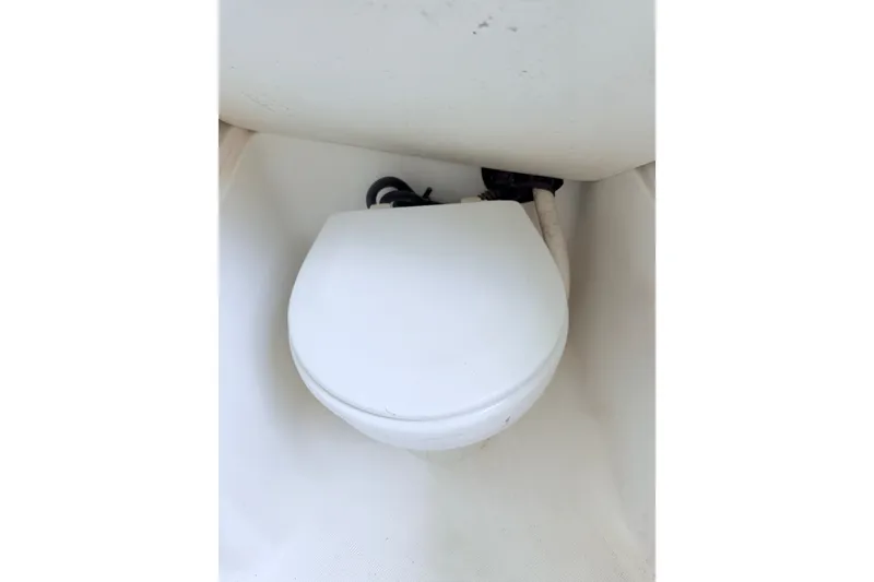 Slide: The Image of Boat toilet in a 2009 Century 3200 Center Console, white and compact design. - 44