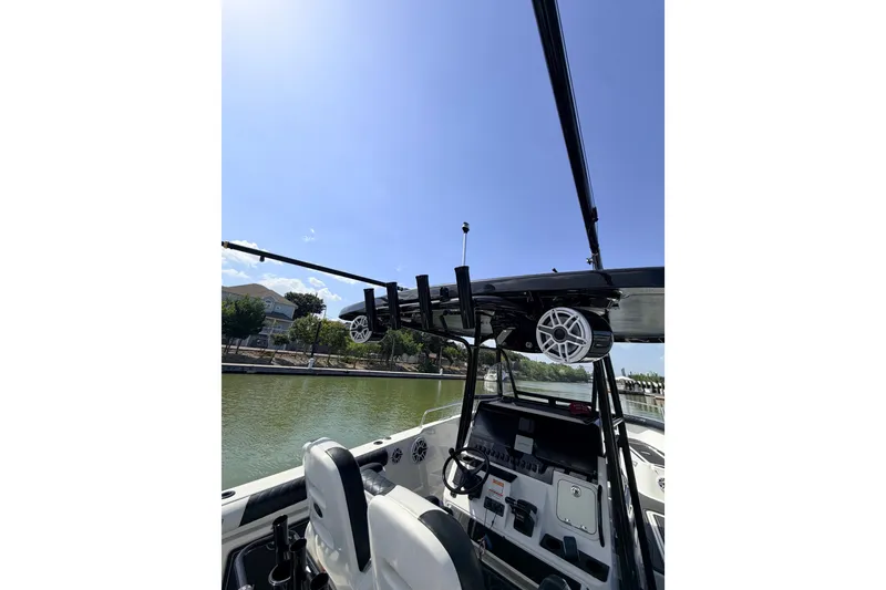 Slide: The Image of 2009 Century 3200 Center Console boat interior with steering wheel and overhead speakers. - 54