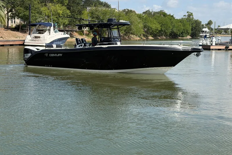 Slide: The Image of 2009 Century 3200 Center Console boat cruising on a calm river. - 6