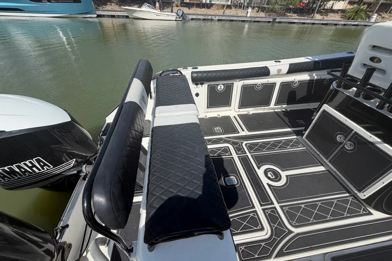 Slide: The Image of 2009 Century 3200 Center Console boat interior with Yamaha engine, docked on calm water. - 10