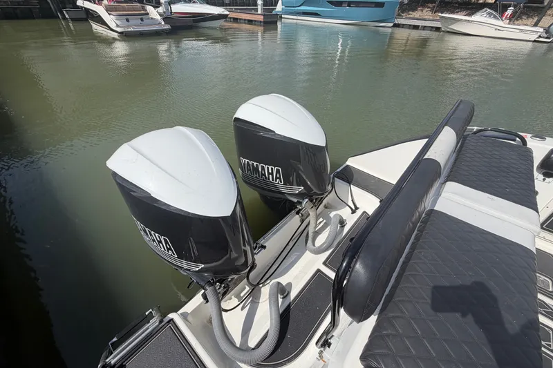 Slide: The Image of Twin Yamaha outboard engines on a 2009 Century 3200 Center Console boat at a marina. - 11