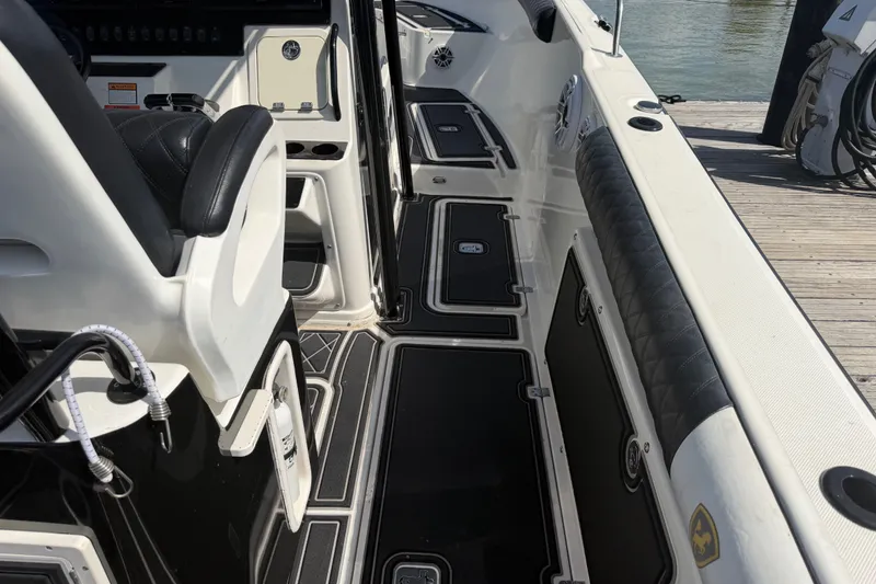 Slide: The Image of 2009 Century 3200 Center Console boat interior with black and white seating and deck. - 13