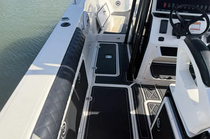 Slide: The Image of 2009 Century 3200 Center Console boat interior with seating and steering wheel. - 12