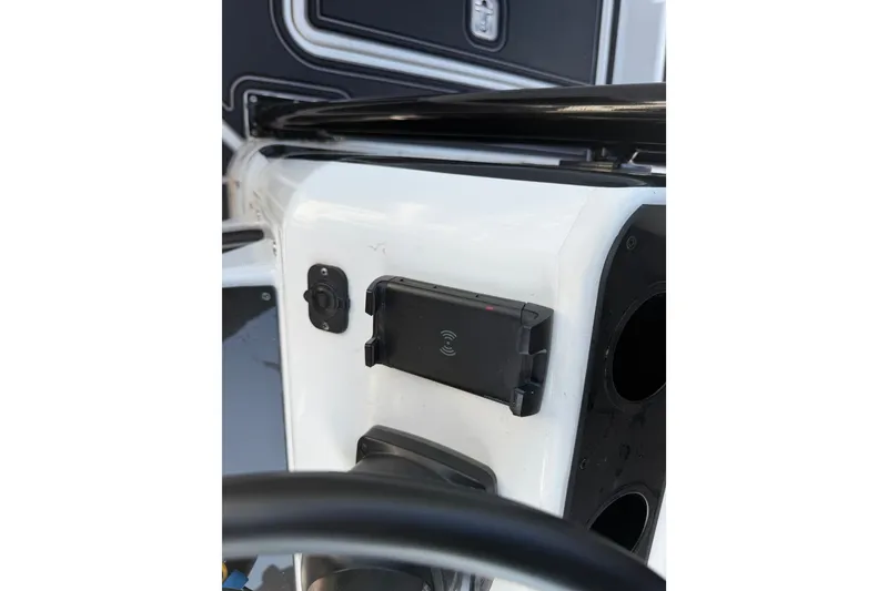 Slide: The Image of Console of a 2009 Century 3200 Center Console boat with mounted device holder. - 35
