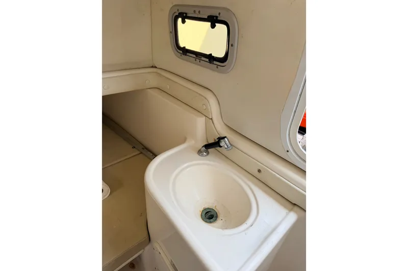 Slide: The Image of 2009 Century 3200 Center Console boat interior sink with window view. - 47