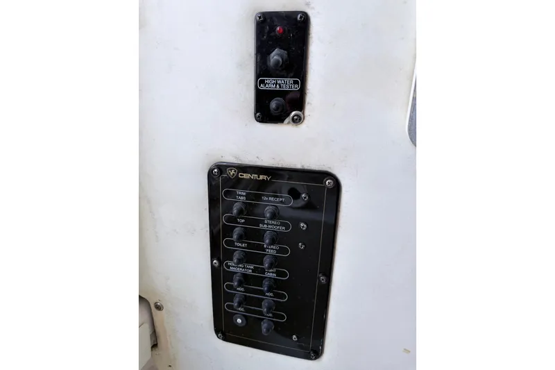 Slide: The Image of Control panel of a 2009 Century 3200 Center Console boat with various switches. - 46