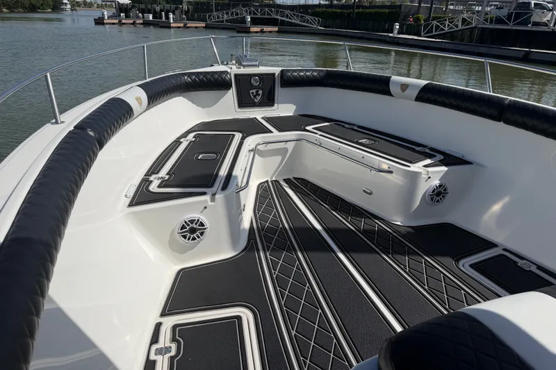 Slide: The Image of 2009 Century 3200 Center Console boat interior with cushioned seating and storage compartments. - 17