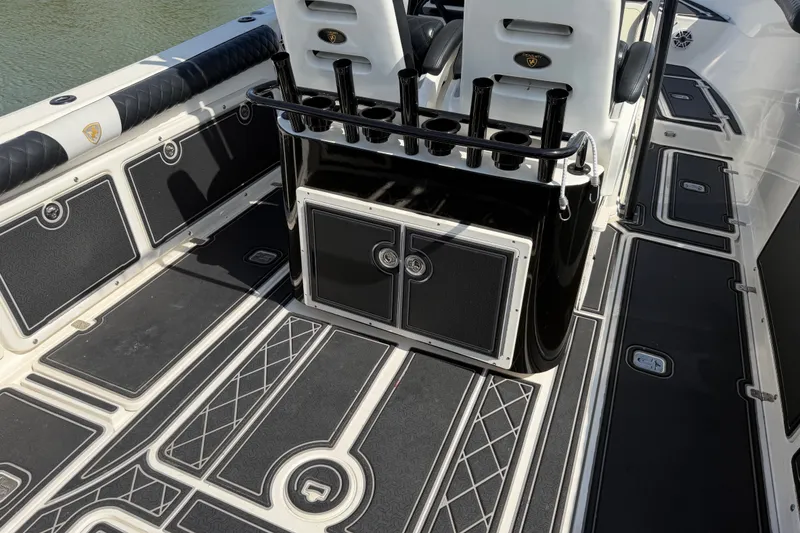 Slide: The Image of 2009 Century 3200 Center Console boat interior with rod holders and storage compartments. - 14