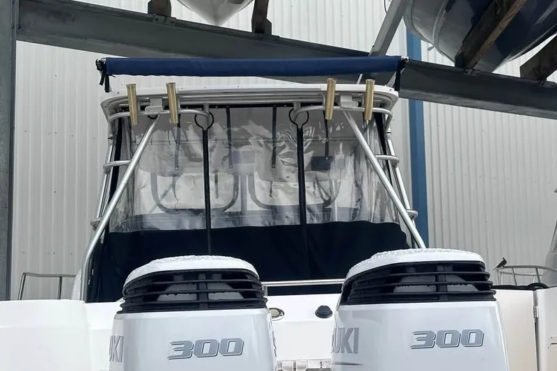 Slide: The Image of 2003 Boston Whaler 295 Conquest with dual Suzuki 300 engines in storage. - 9