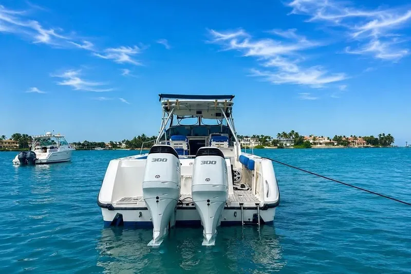 Slide: The Image of 2003 Boston Whaler 295 Conquest boat with twin engines on clear blue water. - 2