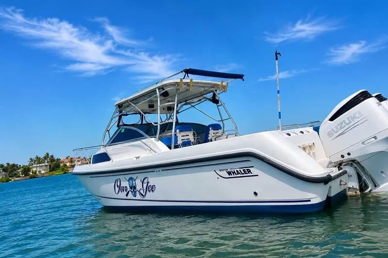 Slide: The Image of 2003 Boston Whaler 295 Conquest boat on clear blue water, sunny day. - 1