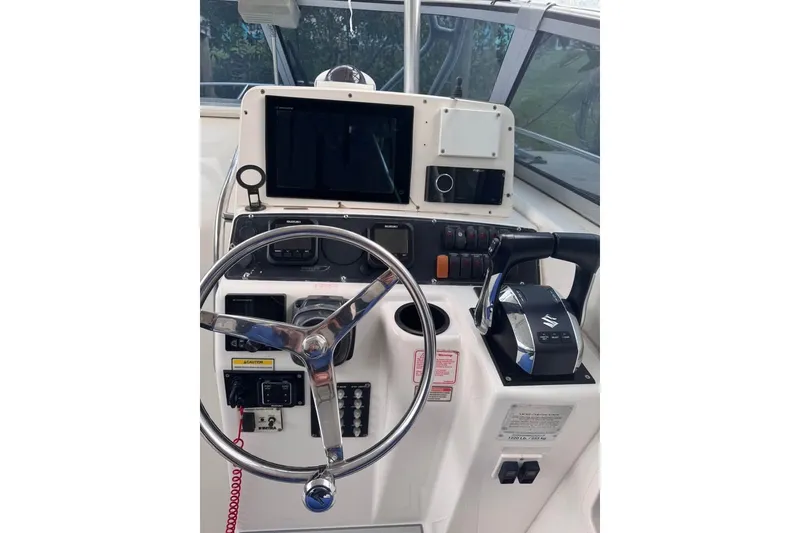 Slide: The Image of Helm of 2003 Boston Whaler 295 Conquest with steering wheel and controls. - 5
