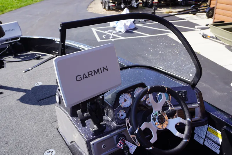 Slide: The Image of Nitro ZV21 Pro 2027 boat dashboard with Garmin navigation system and steering wheel. - 13