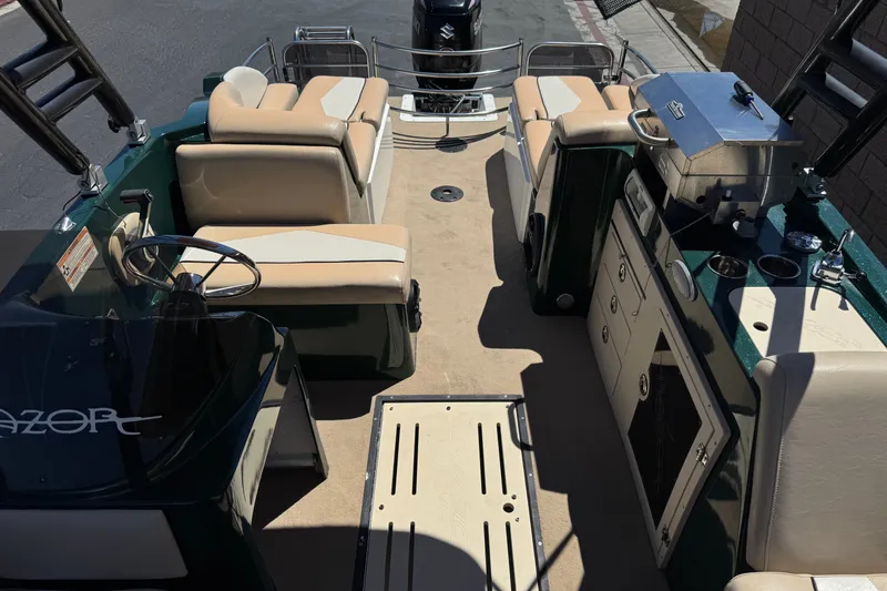 Slide: The Image of 2019 Razor 258 pf boat interior with seating, steering wheel, and grill. - 19