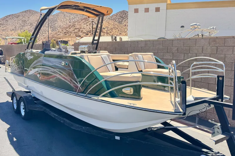 Slide: The Image of 2019 Razor 258 pf boat on trailer, parked outdoors with scenic mountain backdrop. - 1