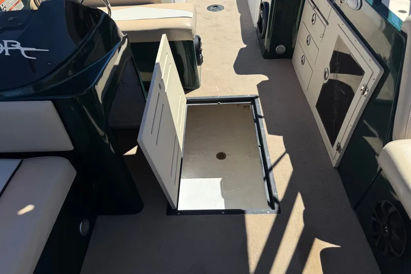 Slide: The Image of Open storage compartment on a 2019 Razor 258 pf boat deck. - 20