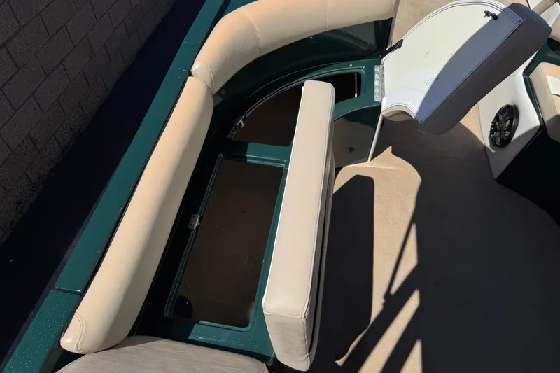 Slide: The Image of 2019 Razor 258 pf boat interior with beige seating and storage compartments. - 17