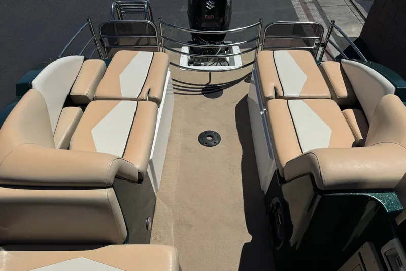 Slide: The Image of Interior of a 2019 Razor 258 pf boat with beige seating and motor. - 24