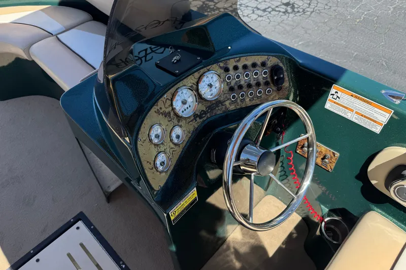 Slide: The Image of Cockpit of a 2019 Razor 258 pf boat with steering wheel and gauges. - 29