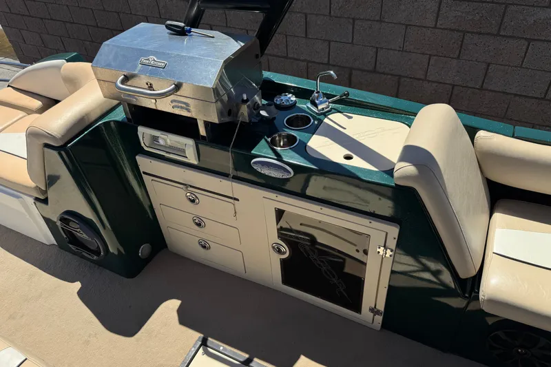 Slide: The Image of Outdoor kitchen setup on a 2019 Razor 258 pf boat with grill and sink. - 21