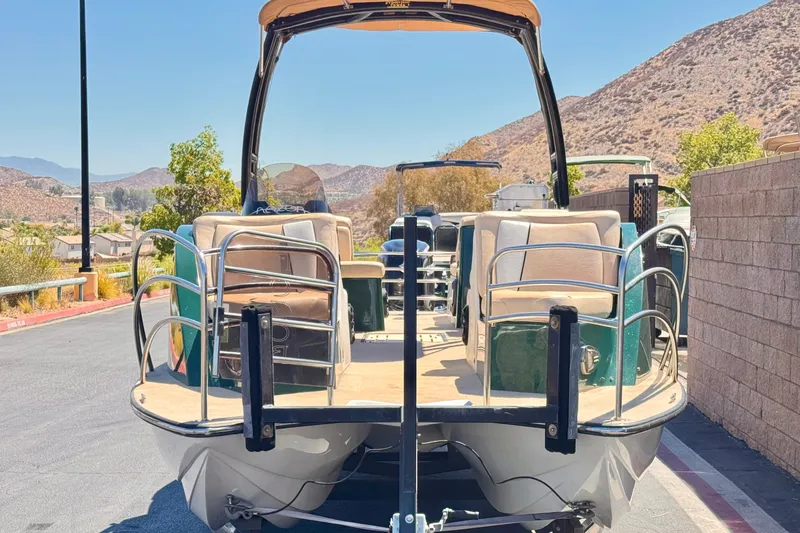Slide: The Image of 2019 Razor 258 pf boat on trailer, scenic mountain backdrop. - 2