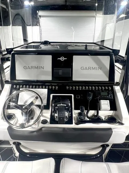 Slide: The Image of Control panel of a 2022 Fountain 34 TE boat with Garmin navigation systems. - 17